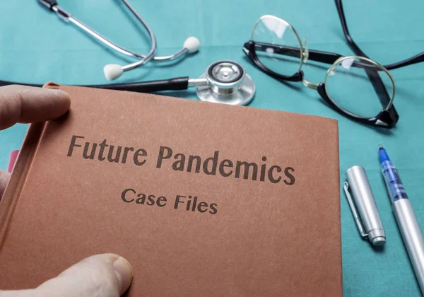 Doctor Holds Book On future pandemics In A Hospital