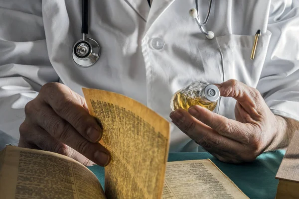 Doctor reading book of old medicine, conceptual image