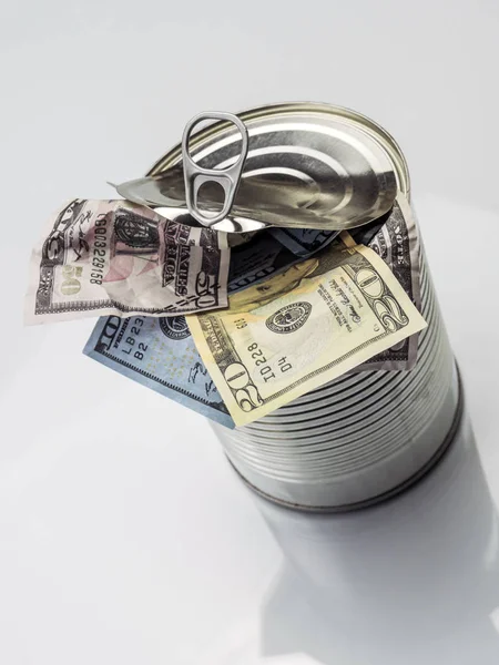 Canned cans full of dollar bills, conceptual image isolated on w — Stock Photo, Image