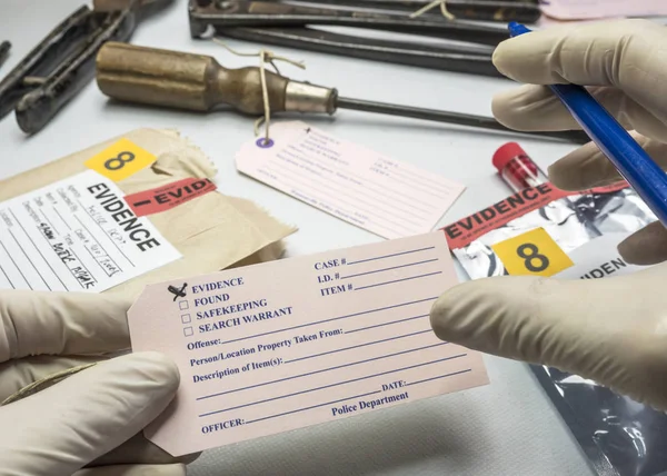 Police expert writes about label evidence number, Various laboratory tests forensic equipment, conceptual image