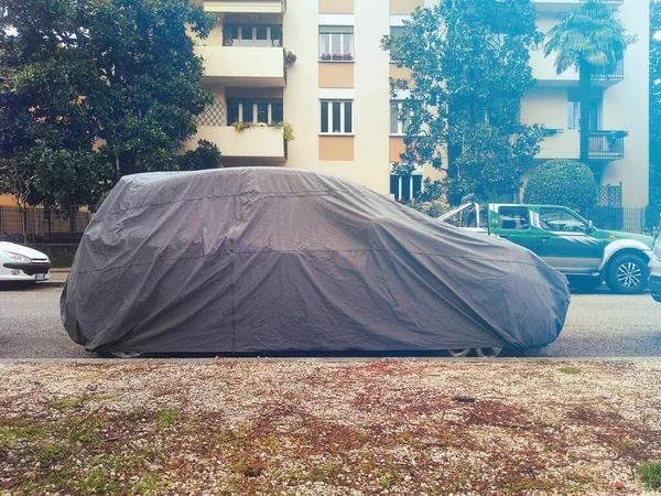 car with protective cover. Parked vehicle with weather protection