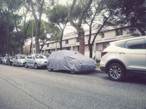 Protective car cover. Sunlight, rain and dust protection (the vehicle is parked on a public road)