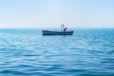 boat maintenance work, man who works to keep the ship clean in the water (copy space available at the bottom of the photo)