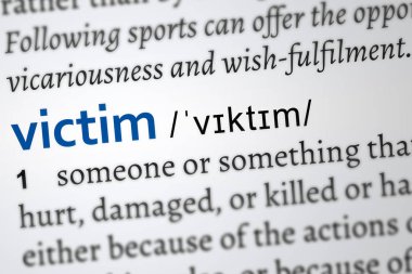 victim in a dictionary page. Word printed in blue color