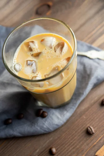 Iced black coffee with milk and ice close-up