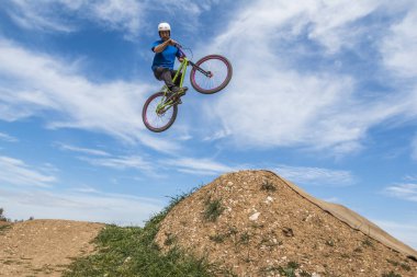 Genç adam dirtjump bisiklet üzerinde uçan