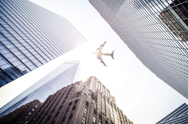 Plane flying over city