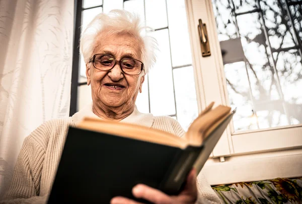 Gammal kvinna läsa bok — Stockfoto