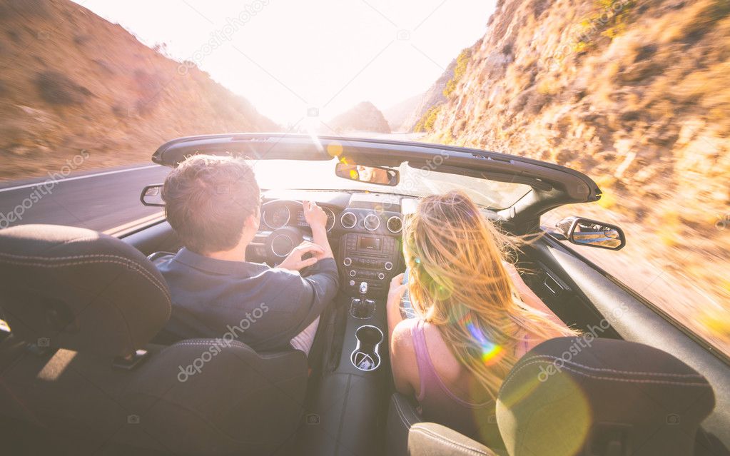 Couple driving on sport convertible car 