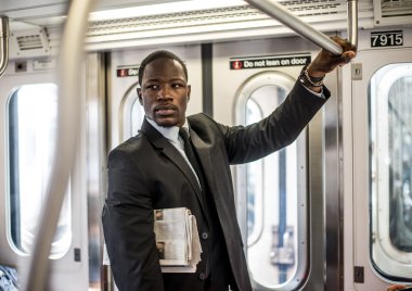 Handsome businessman in subway clipart