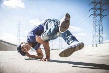 B-boy breakdancing outdoors clipart