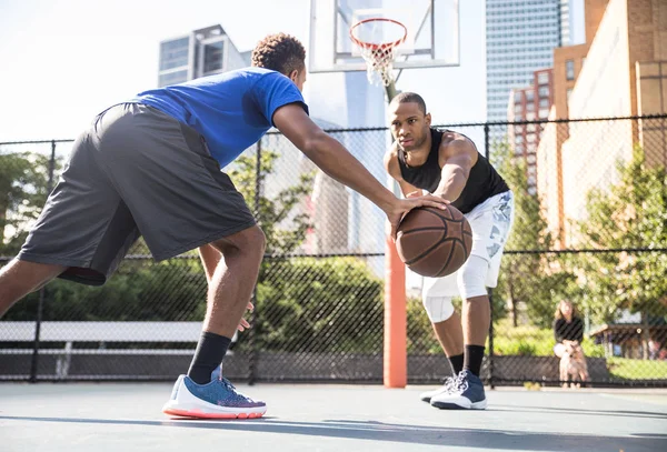 Basketball players training on court