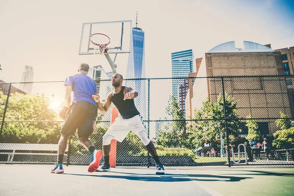 Basketball players training on court