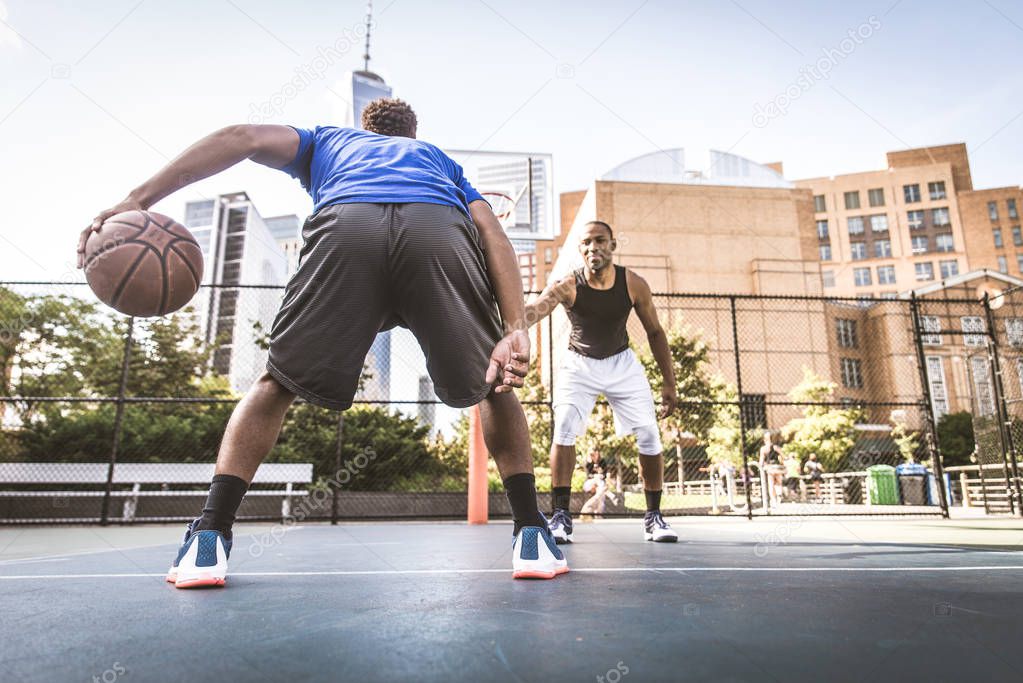 Basketball players training on court