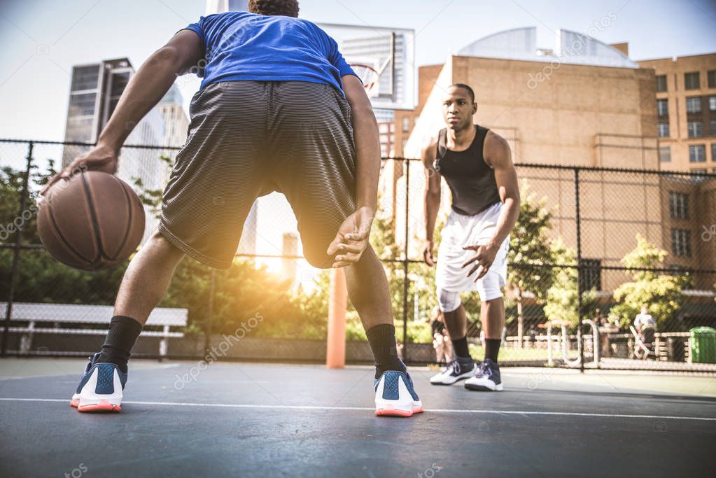 Basketball players training on court