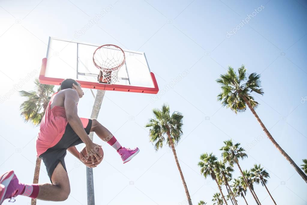 Basketball player making dunk