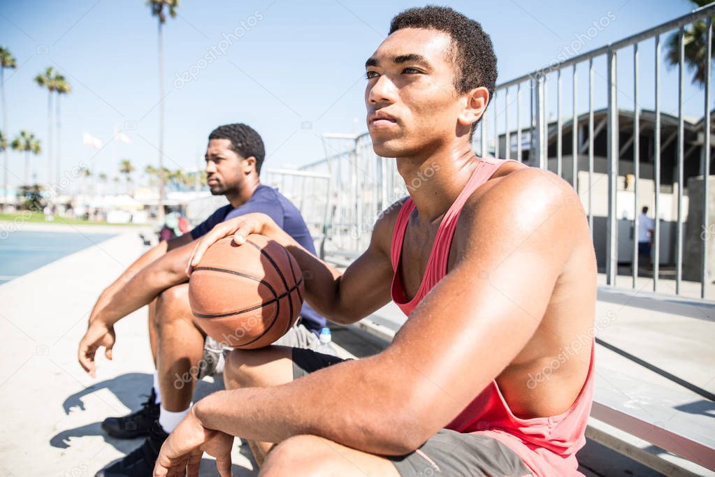 Basketball players resting after competition