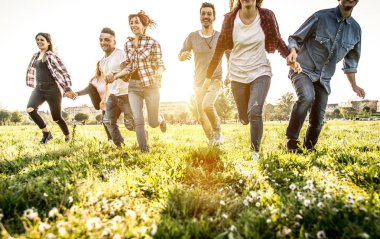 Friends running happily in grass clipart