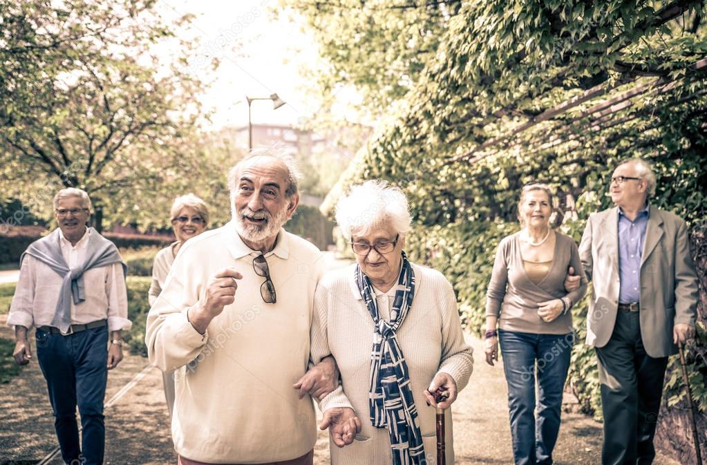Smiling old people walking