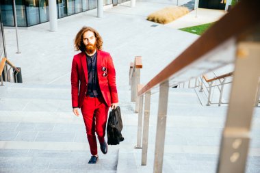 Açık havada yürüyen genç hipster adam