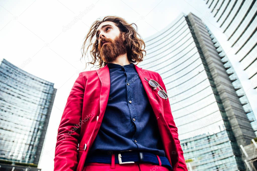 Hipster man walking in red suit 