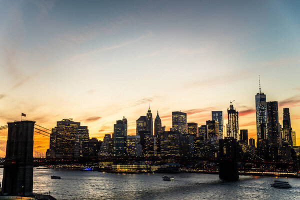Manhattan skyline and Brooklyn Bridge at sunset