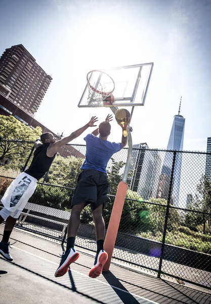 Basketball players playing on court