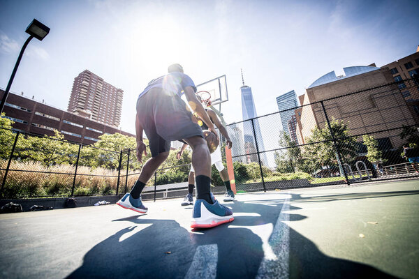 Basketball players playing on court