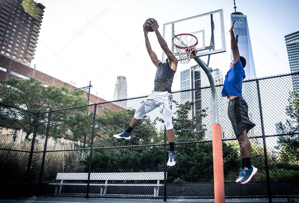 Basketball players playing on court