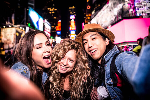 Friends taking selfie in Times Square 