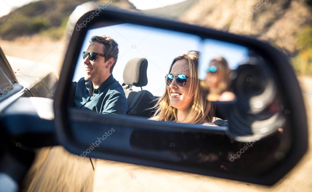 Couple in convertible car