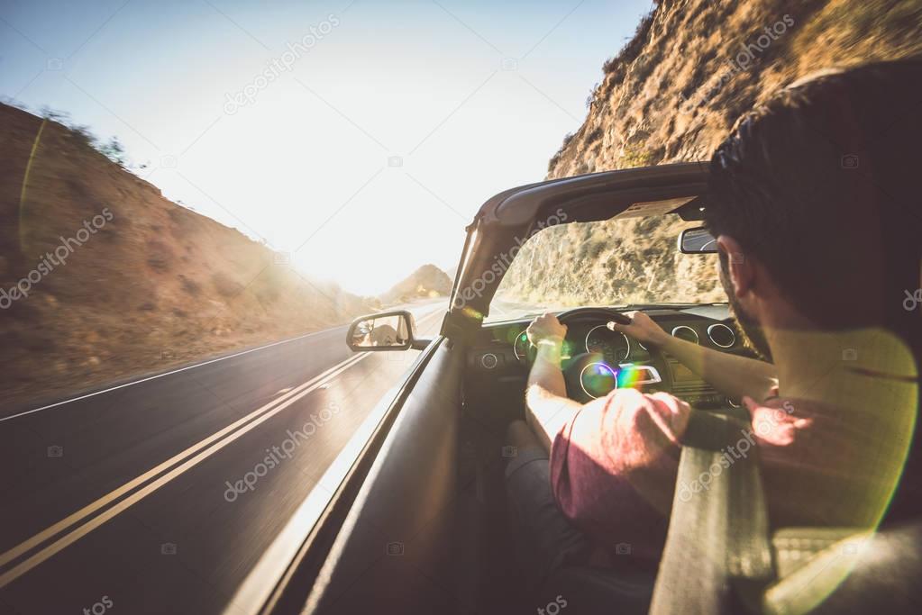 Man driving convertible car in Los angeles, santa monica