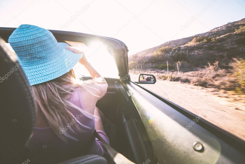 Woman on convertible car