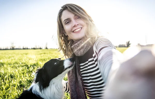 Woman playing with border collie — Stock Photo, Image