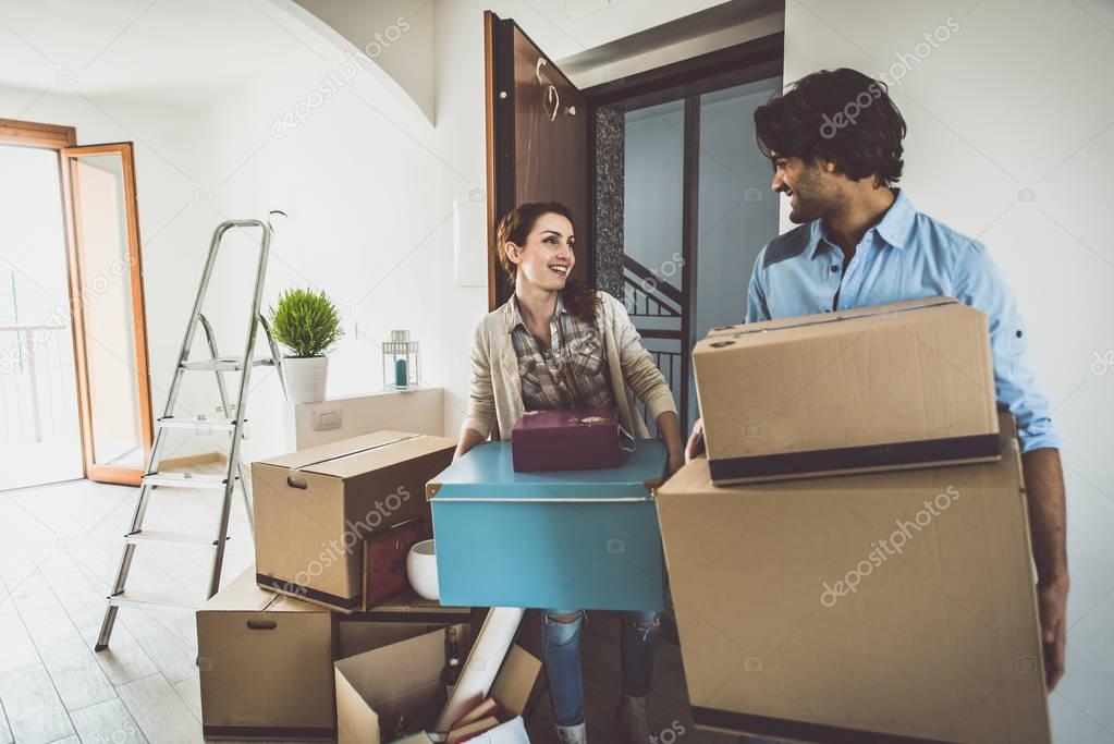 Young couple moving in into new apartment