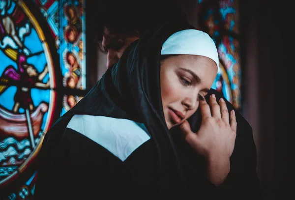 Nun and priest praying and spending time in the monastery — Stock Photo, Image