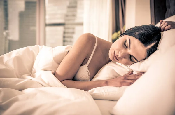 Woman sleeping and dreaming in bed — Stock Photo, Image