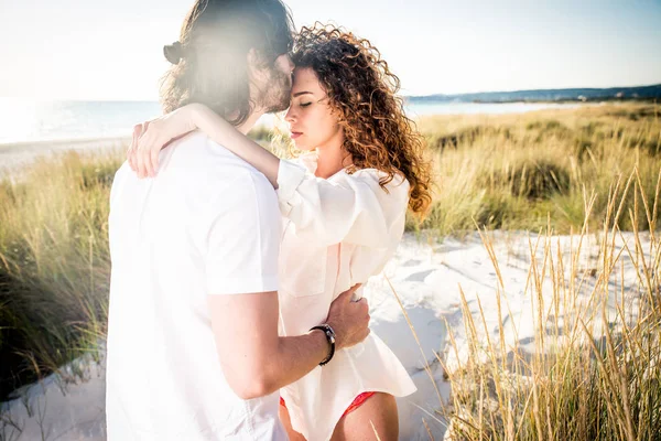 Junges Paar teilt glückliche und verliebte Stimmung am Strand — Stockfoto