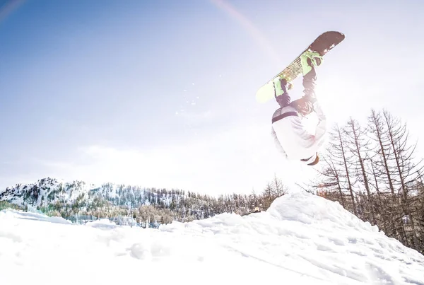 Snoboarder performing tricks on the snow Royalty Free Stock Photos