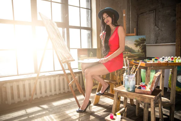 Young woman painter in her studio make some art