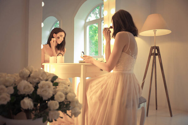 Beautiful woman with fancy wedding dress make preparations for t