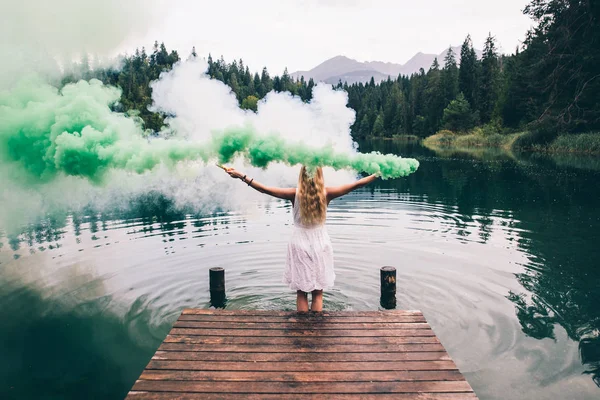 Retrato artístico com mulher usando bombas de fumaça em uma bela na — Fotografia de Stock