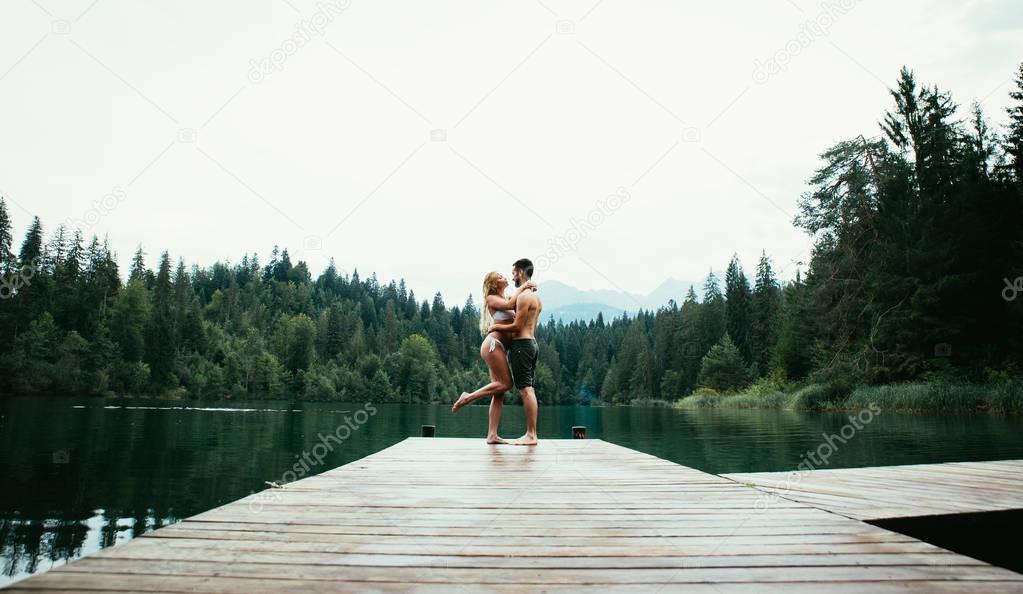 Young couple having fun at the lake in the morning