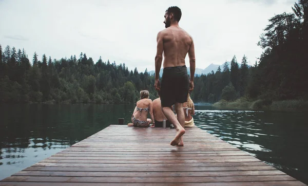 Gruppo di amici che si divertono al lago al mattino — Foto Stock