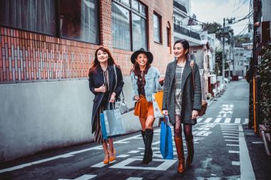 Group of japanese women spending time in Tokyo, making shopping  clipart