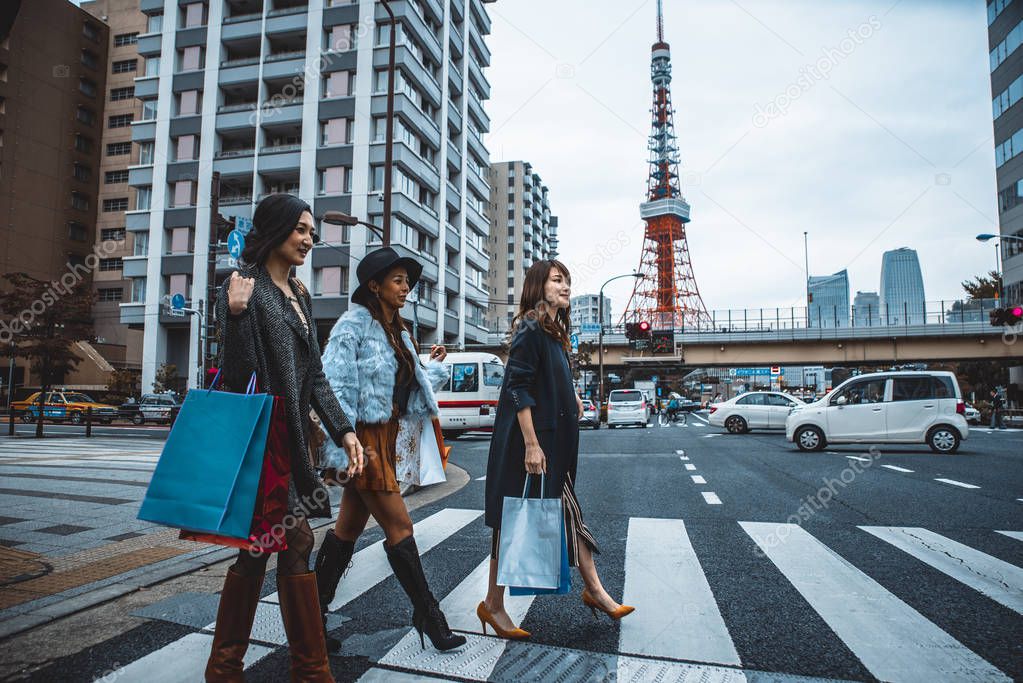 Group of japanese women spending time in Tokyo, making shopping 