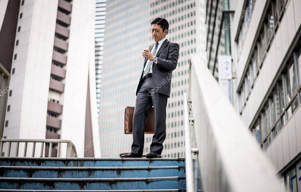 Senior business man moments on the streets of Tokyo