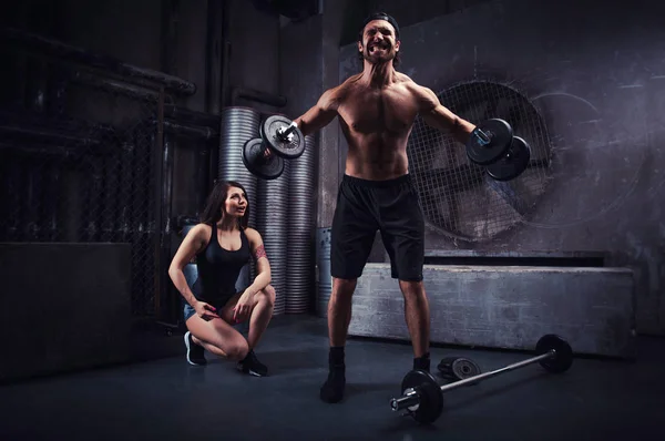 Young people making functional training in the grungy gym