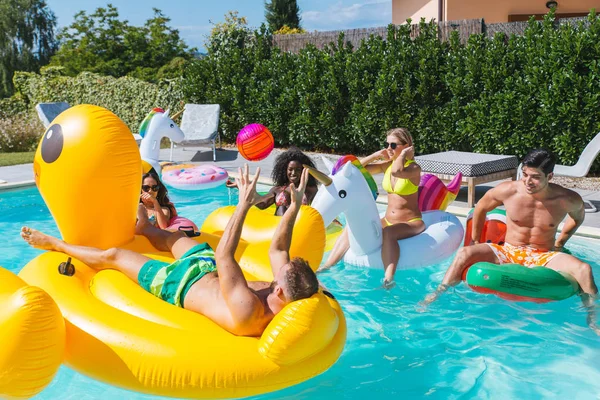 Amigos divirtiéndose en una piscina — Foto de Stock