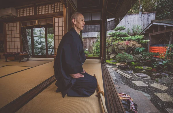 Japanese man meditating in his garden — Stock Photo, Image